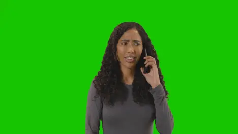 Frustrated Woman Talking On Mobile Phone Against Green Screen Before Hanging Up 1