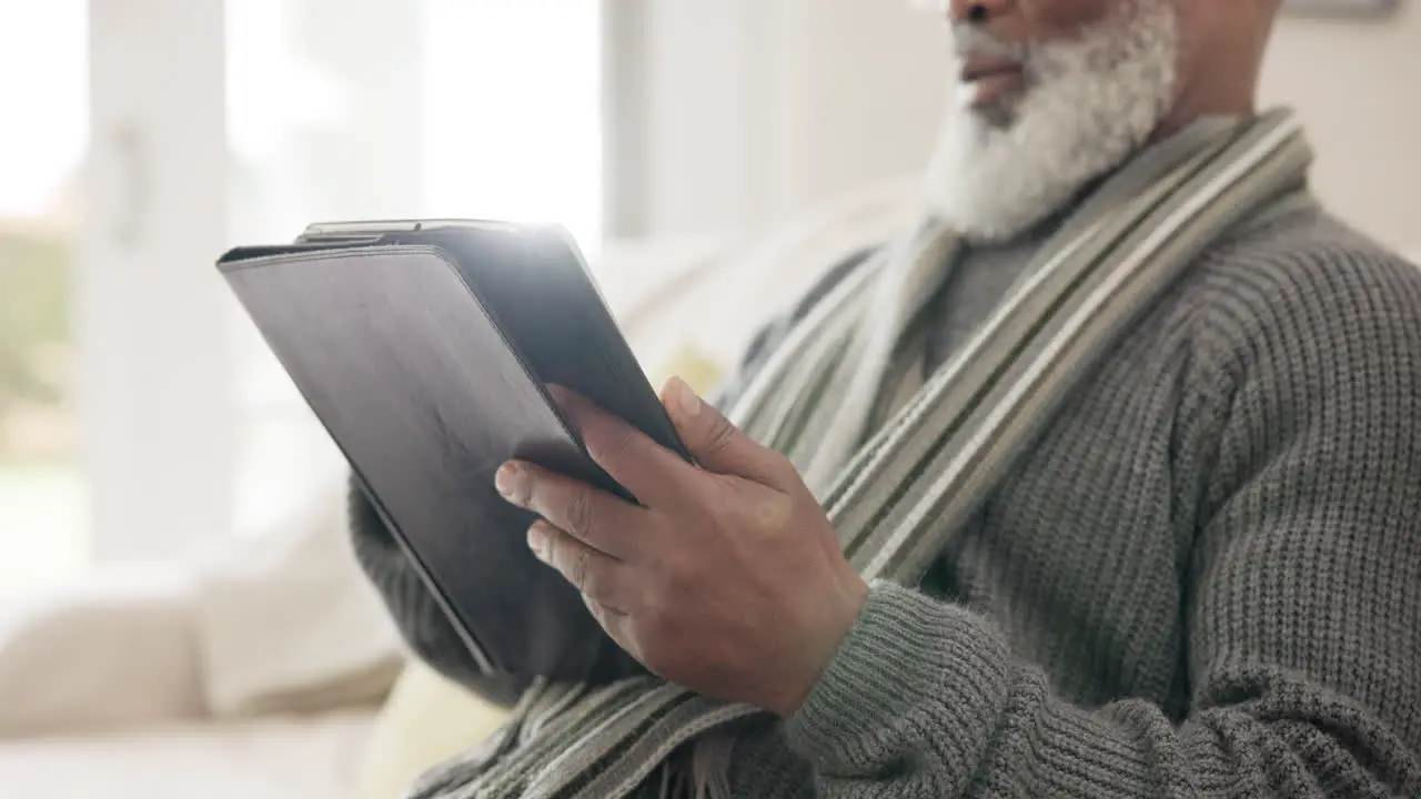 Old man tablet and scroll reading in home