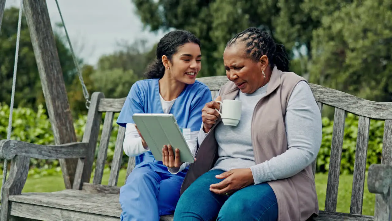 Happy woman nurse and patient with tablet on park