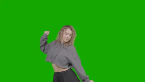 Studio Shot Of Young Woman Having Fun Dancing Against Green Screen 9