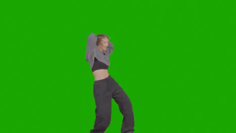 Studio Shot Of Young Woman Having Fun Dancing Against Green Screen 34