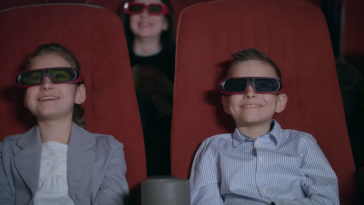 Children in 3D glasses watching movie in the cinema