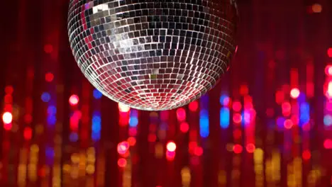 Close Up Of Mirrorball In Night Club Or Disco With Flashing Strobe Lighting And Sparkling Lights In Background