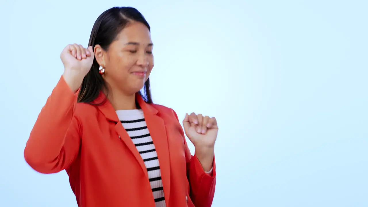 Happy dancing and young woman in a studio