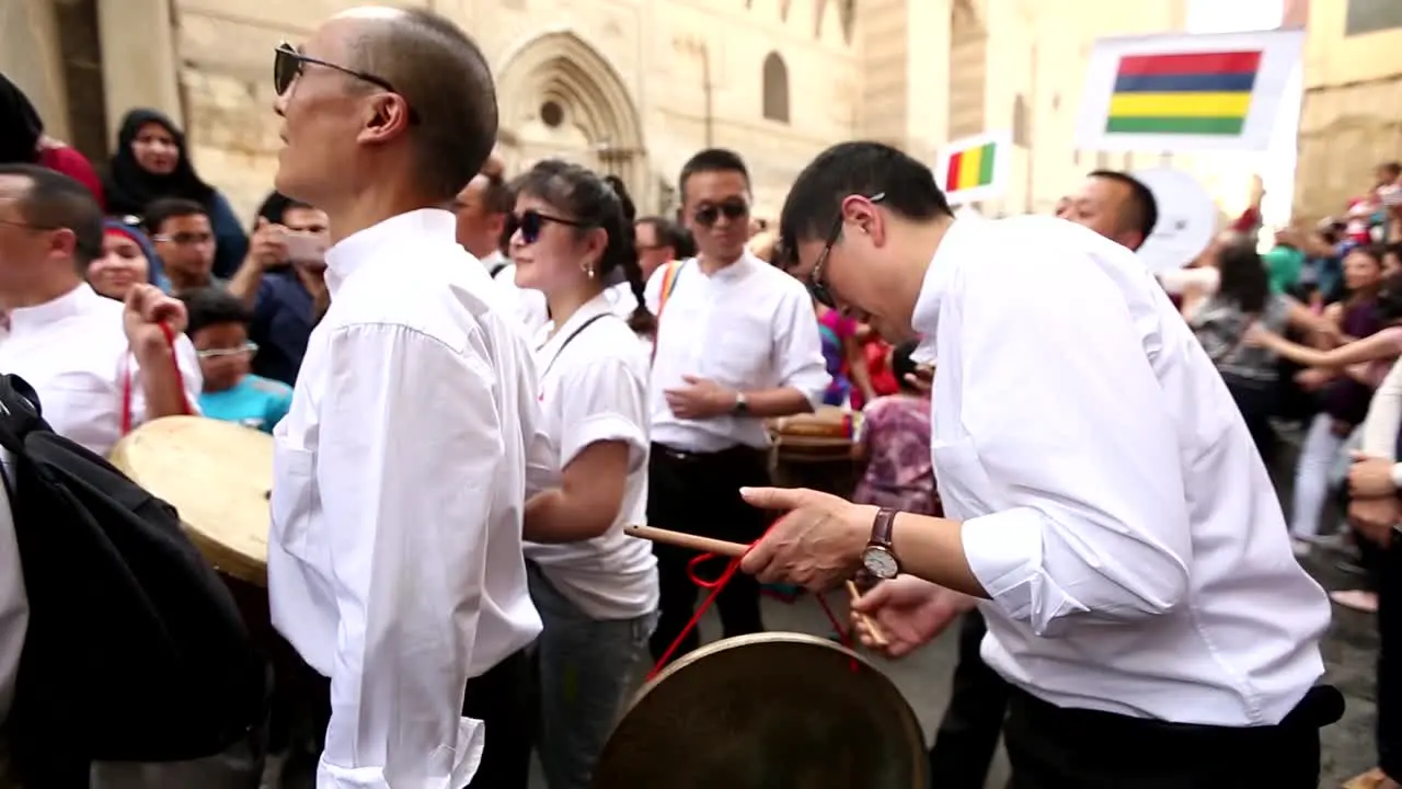 A Chinese man plays traditional Chinese music during a popular festival in the streets of Cairo