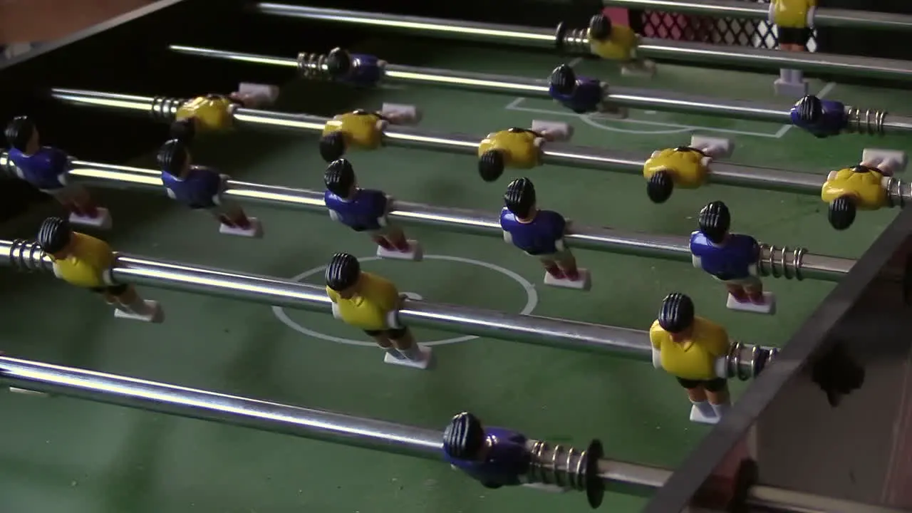 kids playing foosball like crazy