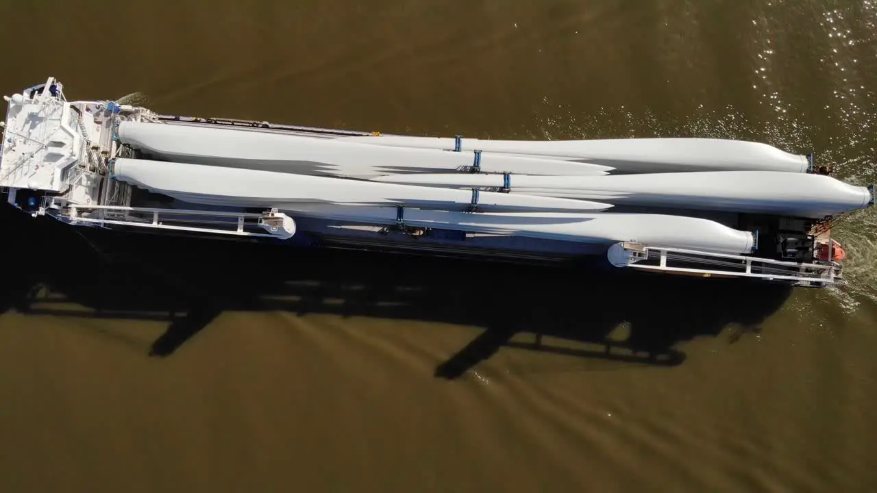 Aerial Birds Eye View Over Symphony Provider Cargo Ship Transporting Wind Turbine Propeller Blades Along Oude Maas