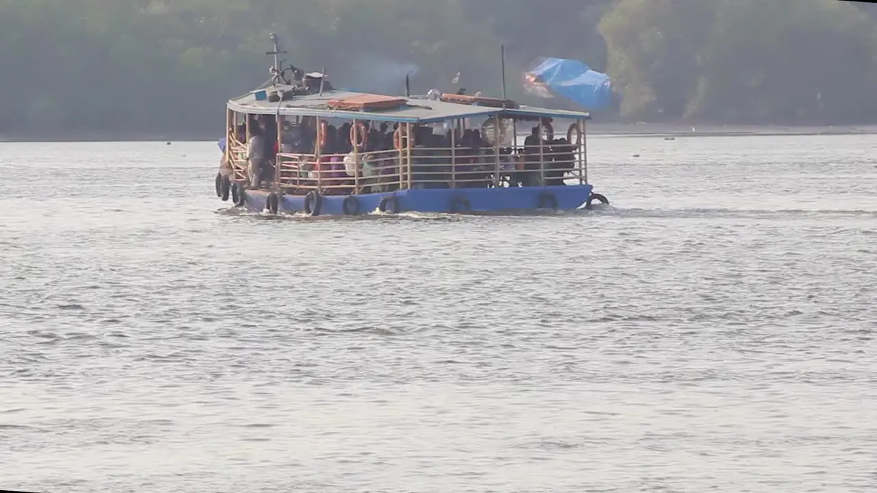 A Ferry boat full of passengers moving towards shore in middle of the bay video background in Full HD