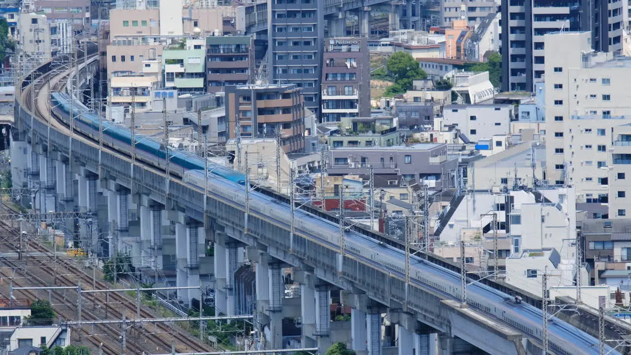 Shinkansen trains riding along railroad tracks