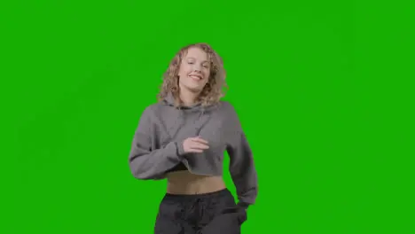 Studio Shot Of Young Woman Having Fun Dancing Against Green Screen 18