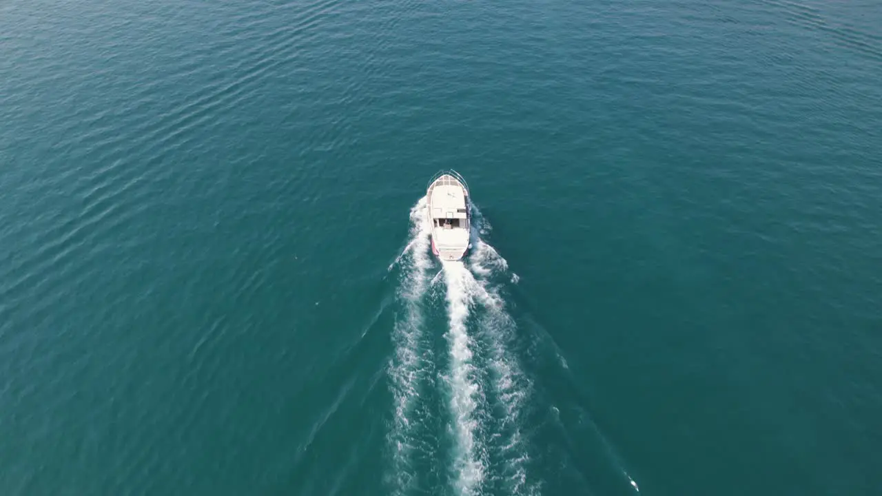 Tracking aerial shot following motor boat on a peaceful sunny summer day Croatia