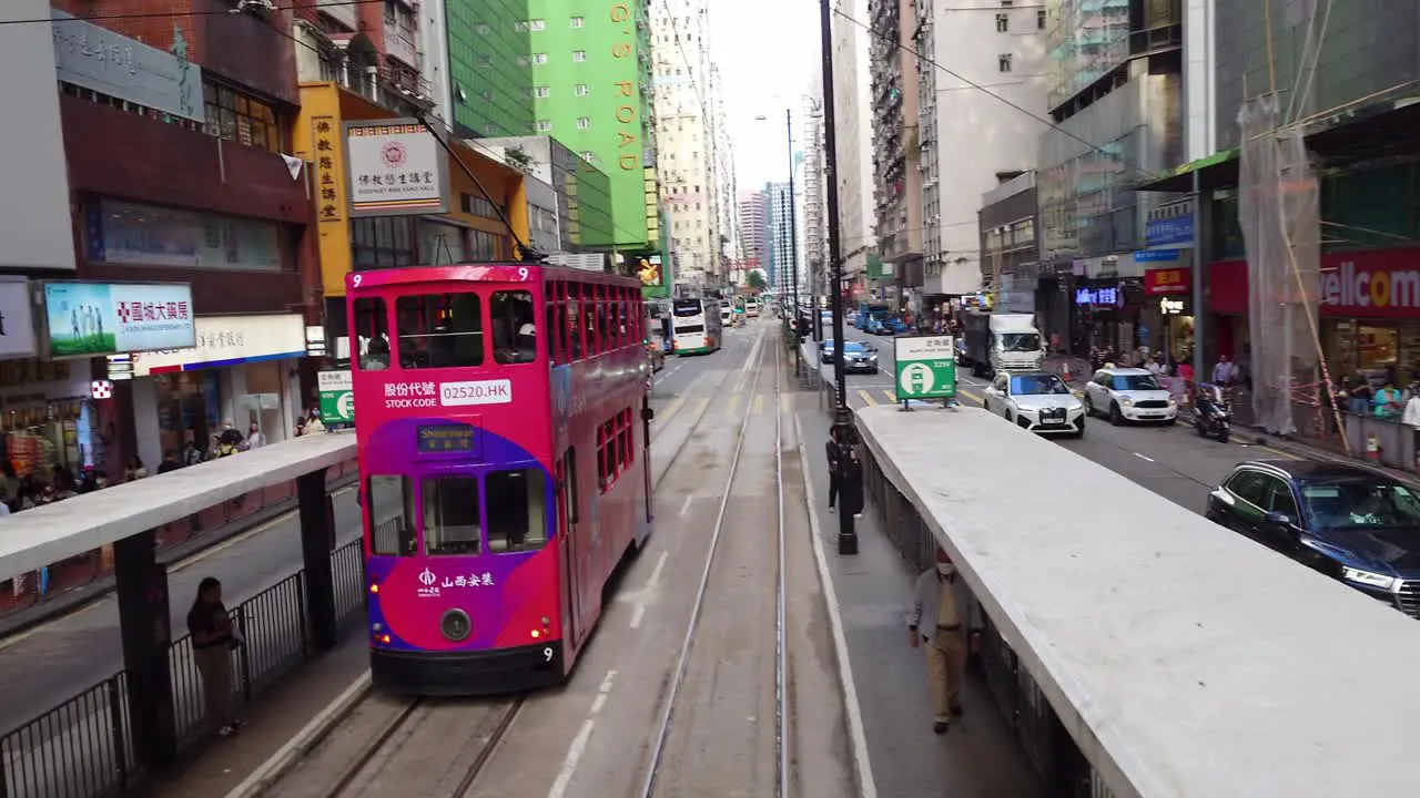 POV Point Of View From Back Of Tram Driving Along Hong Kong Downtown Crowded City Cityscape Car Street