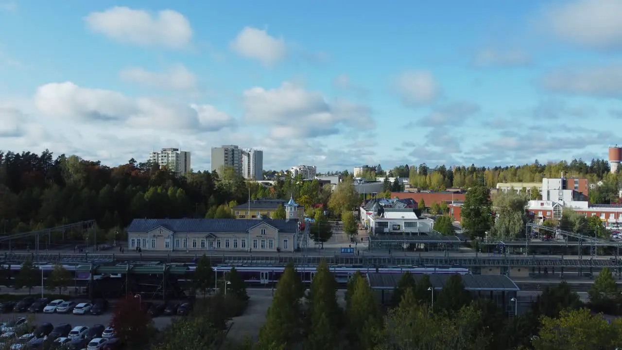 Rising aerial reveals train pulling into Kerava Station from Helsinki