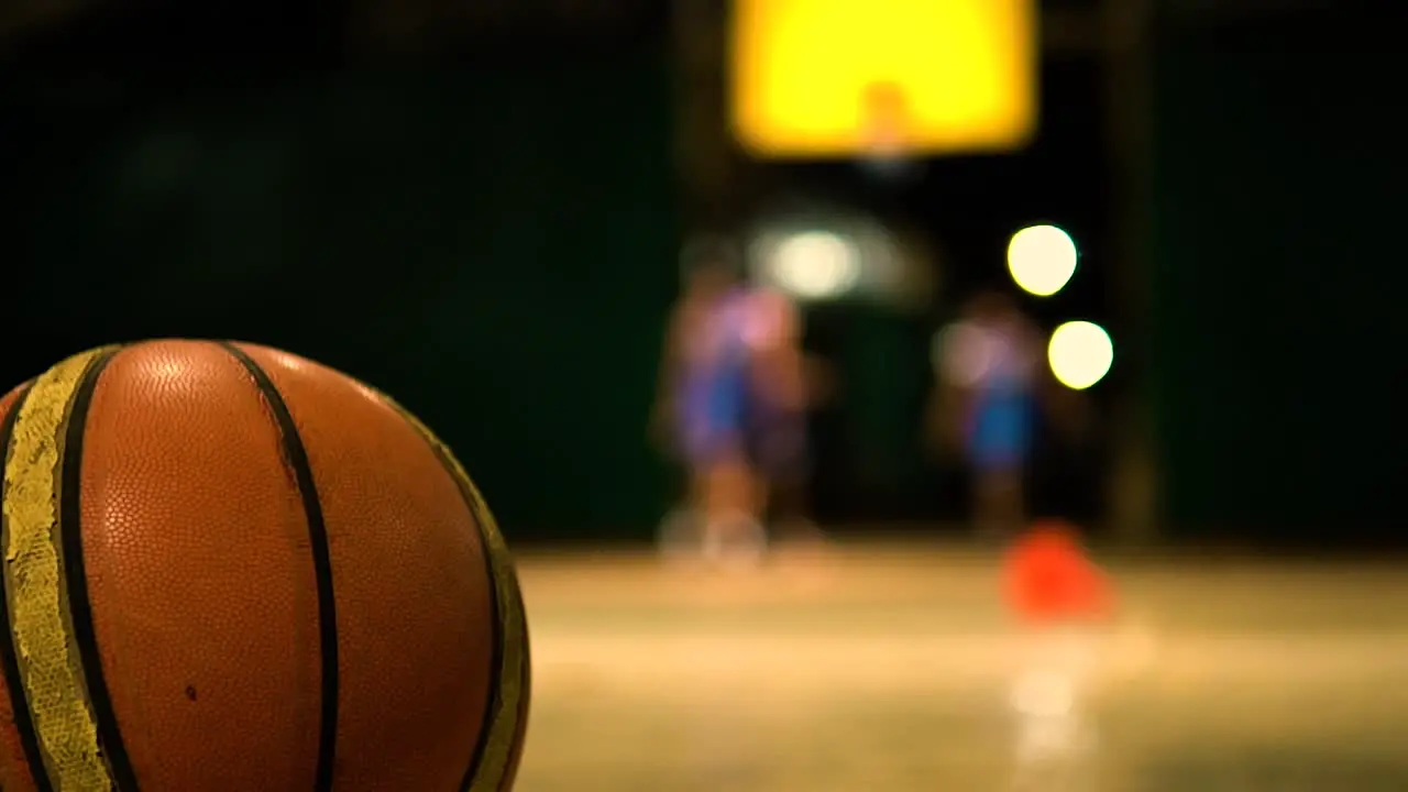 basket ball on the ground while players are on the background