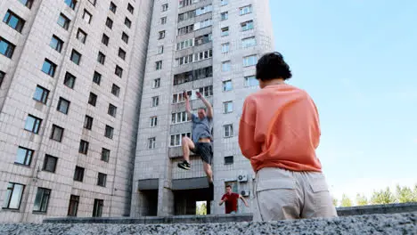 Woman recording friends doing parkour