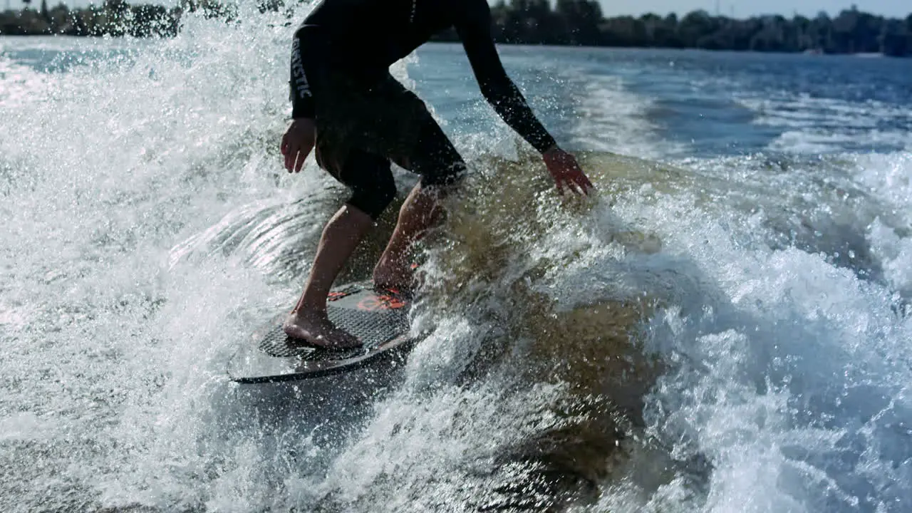 Man riding surf on waves of river Wakesurfing sport Extreme lifestyle