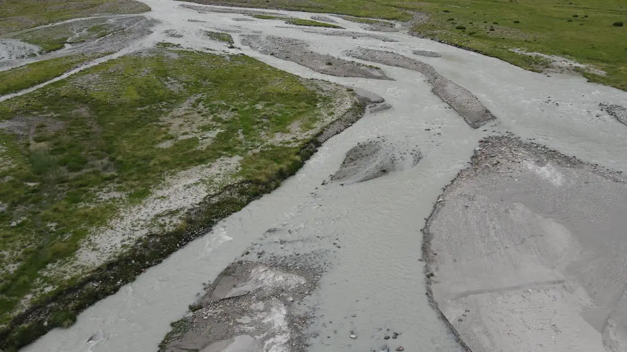 wide angle drone video of the beautiful mountains in northern Italy with a giant waterfall and river