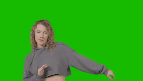 Studio Shot Of Young Woman Having Fun Dancing Against Green Screen 17