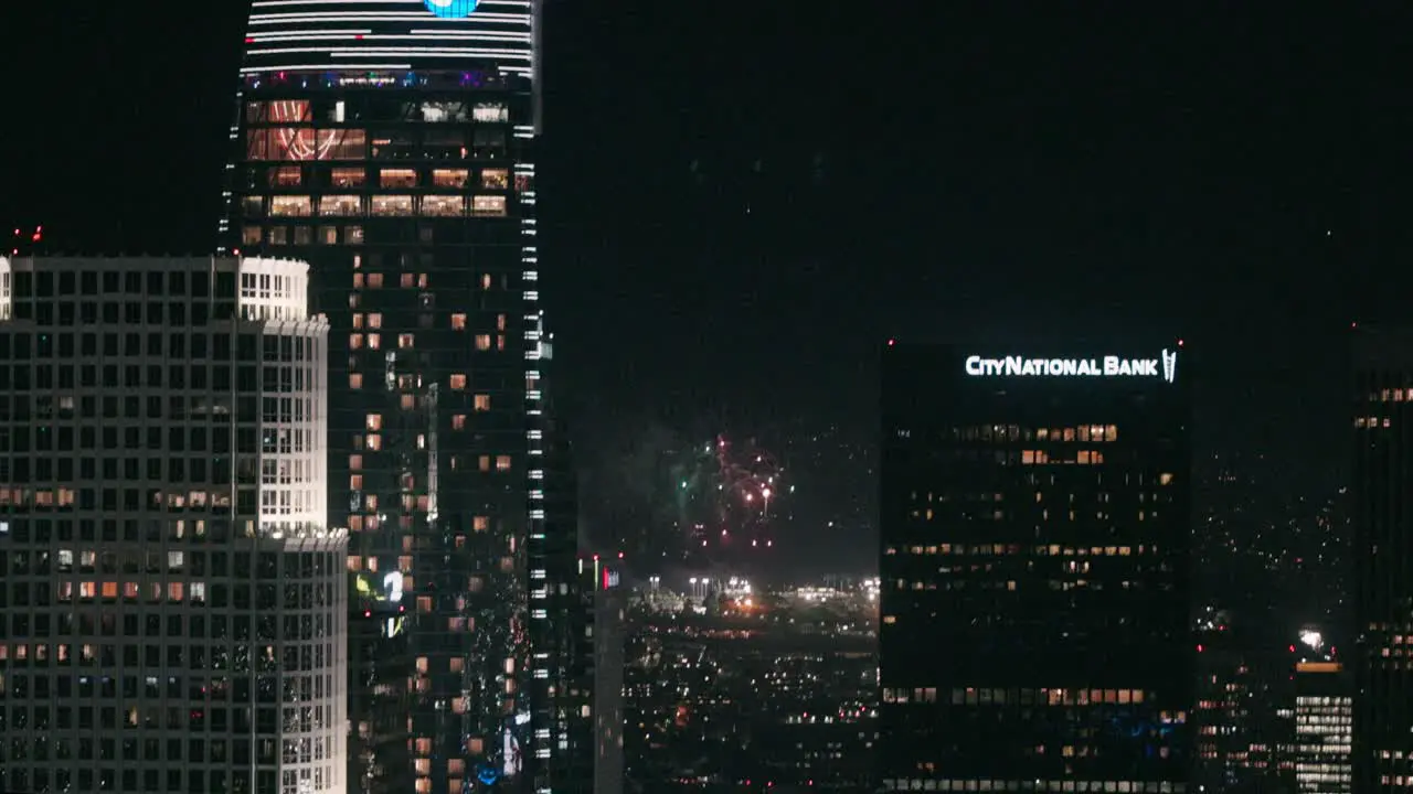 Firework display in the distance behind skyscrapers of downtown LA