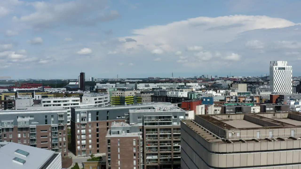 Concrete buildings in Helsinki Finland in city's horizon drone shot