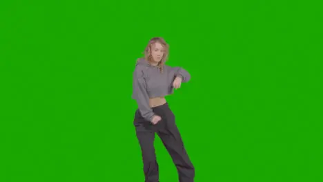 Studio Shot Of Young Woman Having Fun Dancing Against Green Screen 38