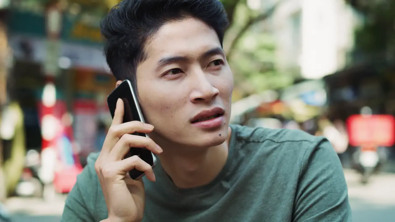 Handheld view of Vietnamese man is on the phone