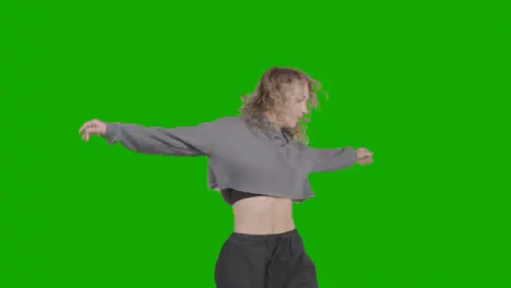 Studio Shot Of Young Woman Having Fun Dancing Against Green Screen 12