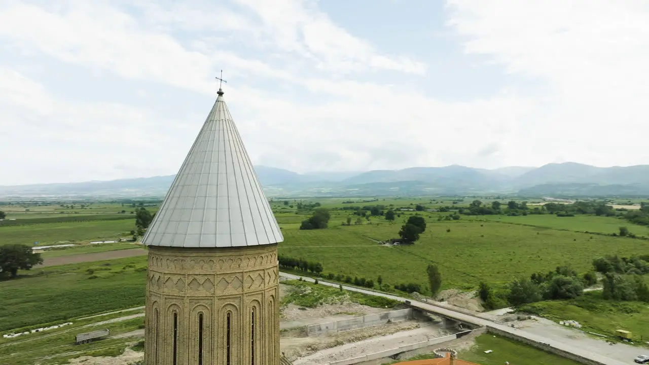 Orthodox Alaverdi cathedral spire with cross above Georgia countryside