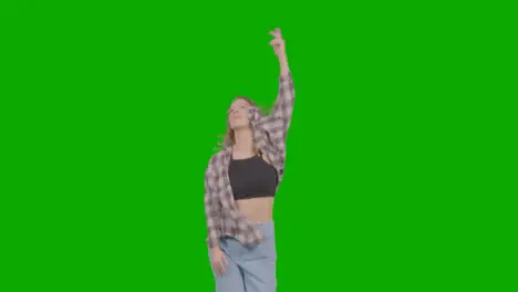 Studio Shot Of Young Woman Having Fun Dancing Against Green Screen 23