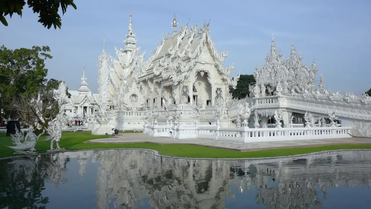 Front movement into the White Temple over the main lake Chiang Rai Thailand