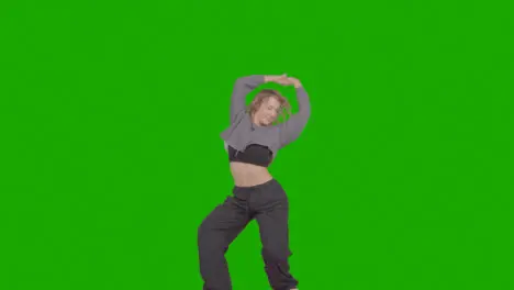 Studio Shot Of Young Woman Having Fun Dancing Against Green Screen 32