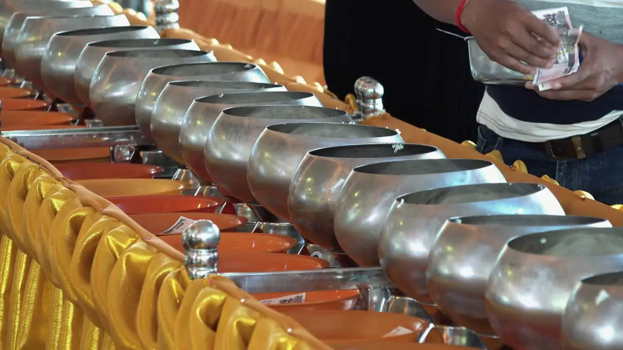 Man Puts Rice in the Monk Pots at the Buddhist Temple