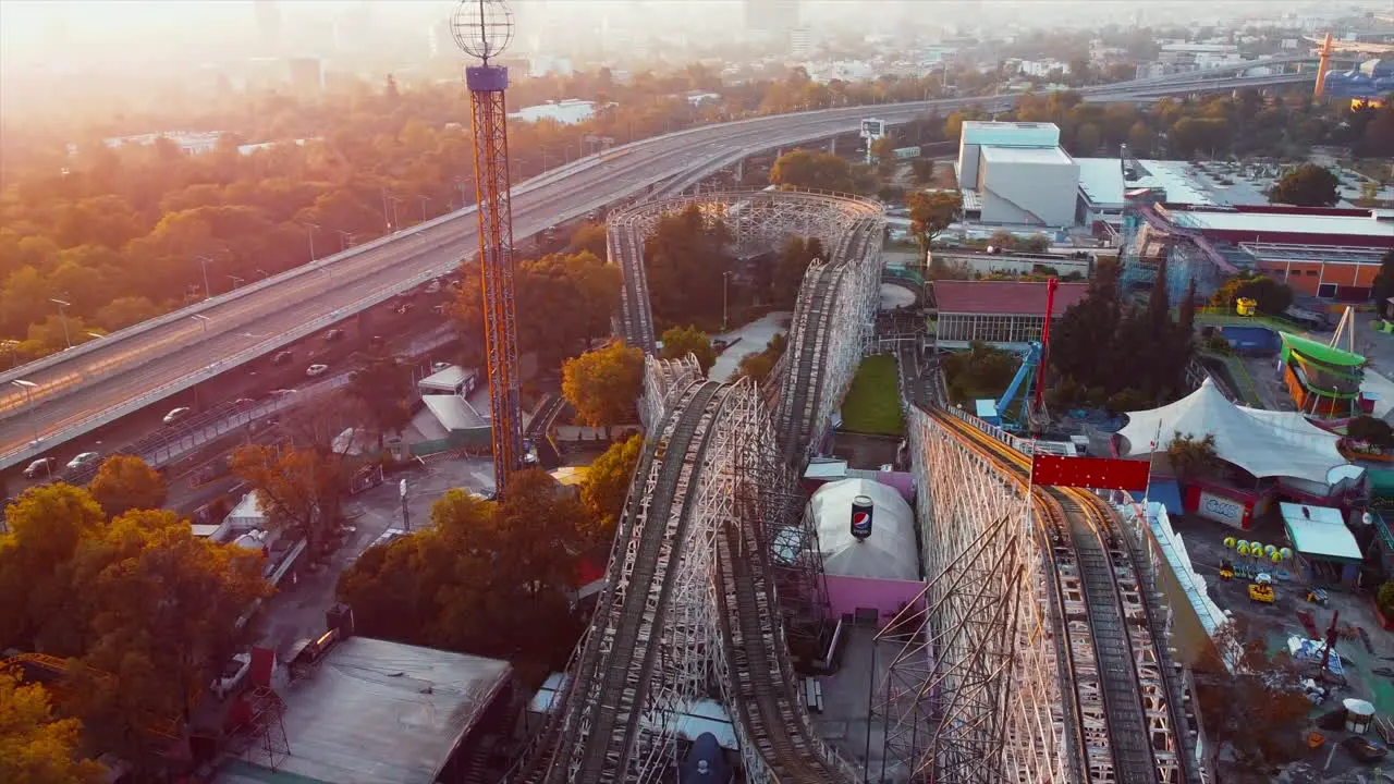 Mexico City June 2022 Sunset top view of business downtown district of Mexico city in background and La Feria amusement park