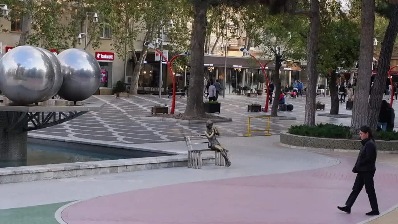 Pedestrians and artwork of Fountain Square in Baku city Azerbaijan