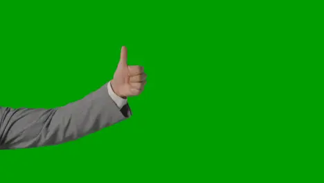 Close Up Of Arm Of Businessman In Suit Choosing Between Thumbs Down And Down Gesture Against Green Screen 1