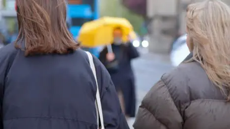 Medium Shot of Two Girls Waiting to Cross Street 