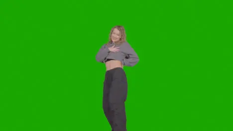 Studio Shot Of Young Woman Having Fun Dancing Against Green Screen 31