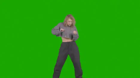 Studio Shot Of Young Woman Having Fun Dancing Against Green Screen 30