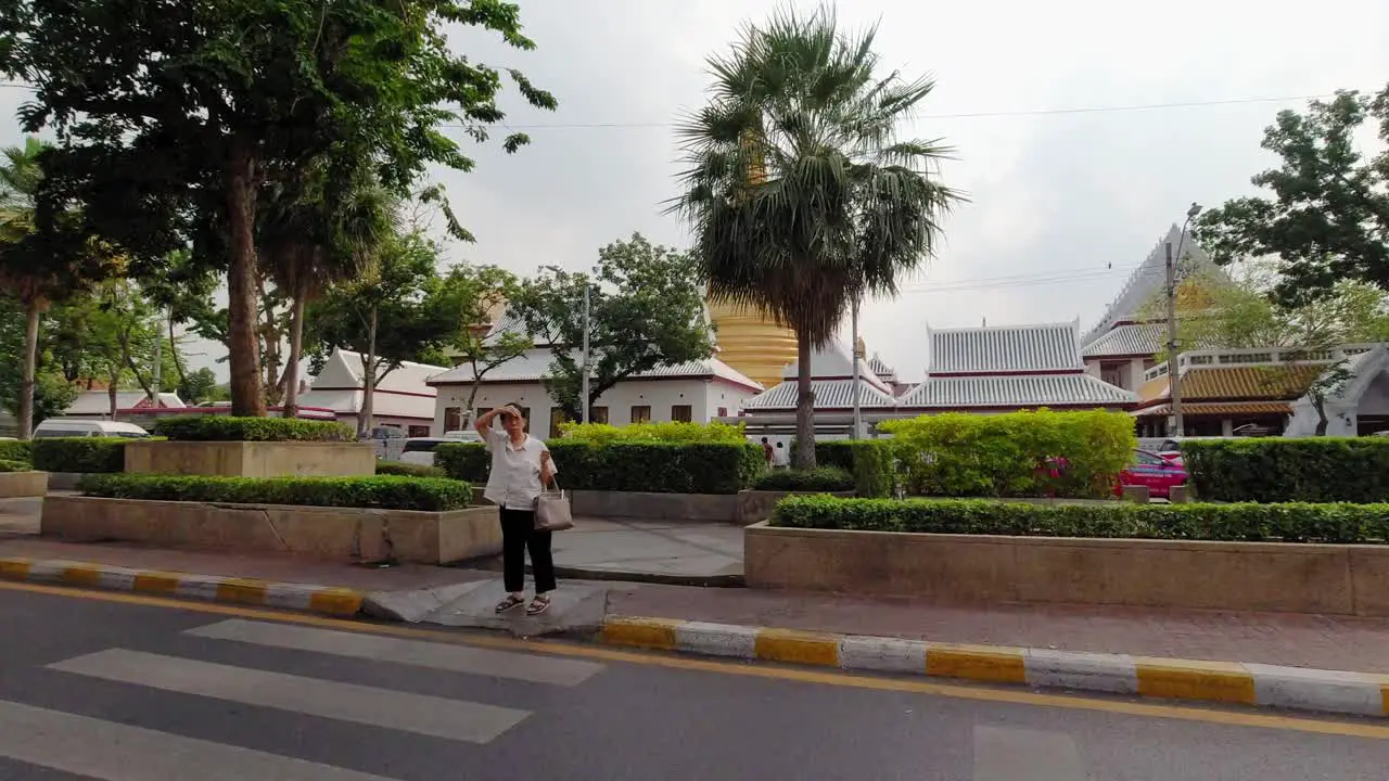 Gold Pagoda in bangkok city in Thailand seen from a moving car