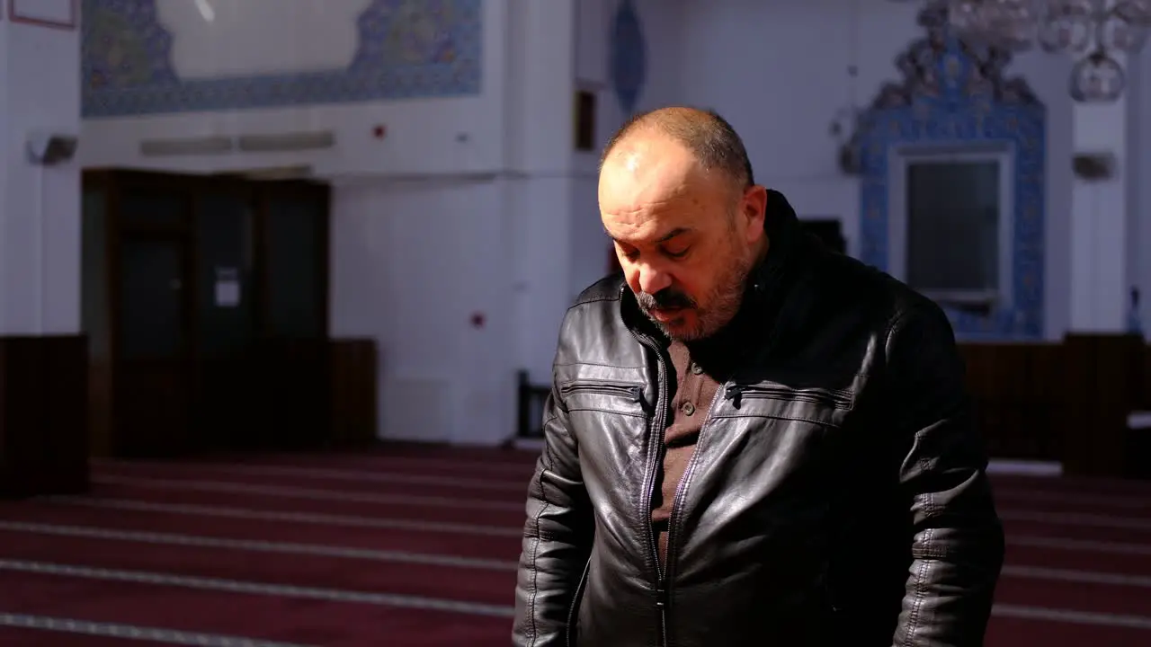 Older Man Stands and Prays in A Mosque 2