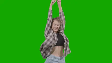 Studio Shot Of Young Woman Having Fun Dancing Against Green Screen 1