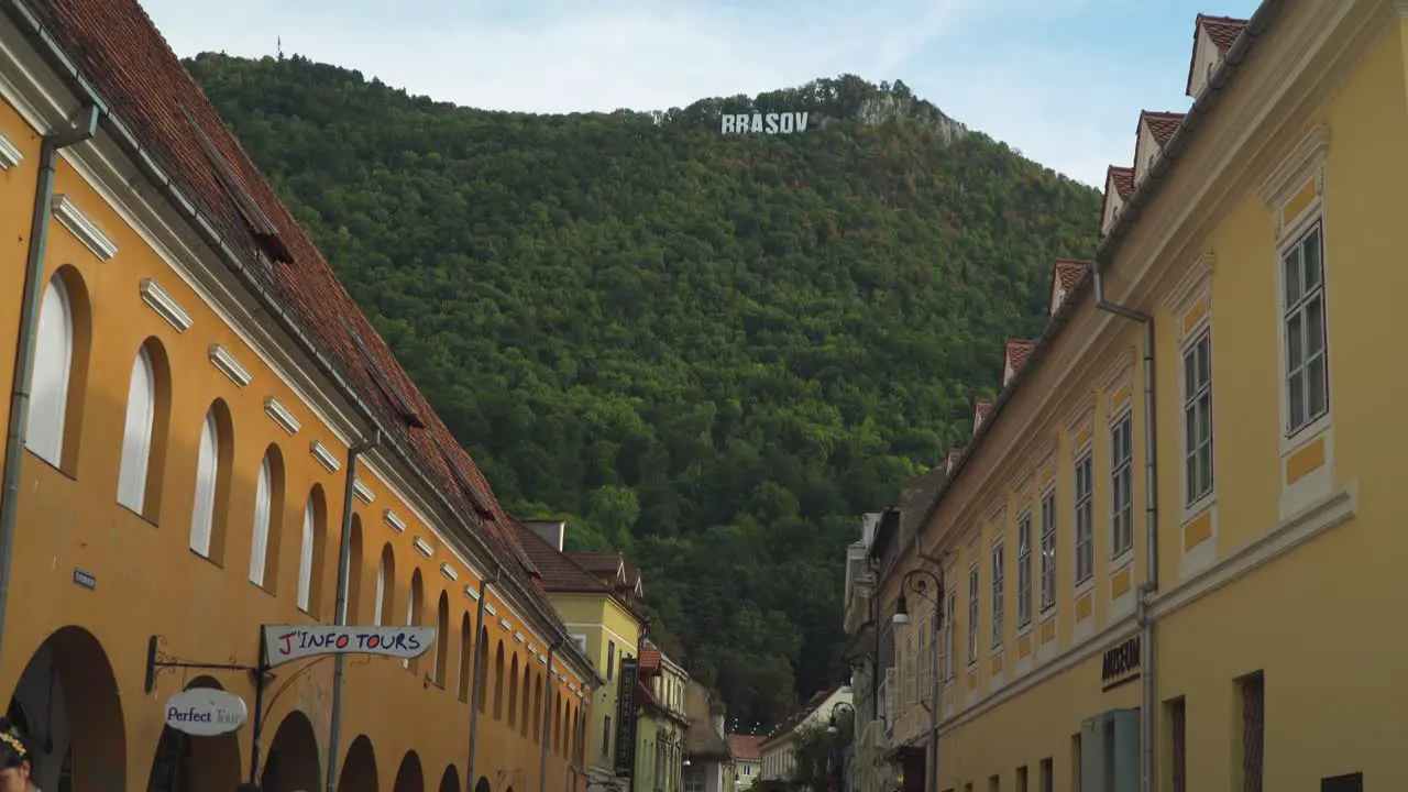 Downward tilt From the mountains to the market road Hiding the Brasov Sign in Brasov Romania