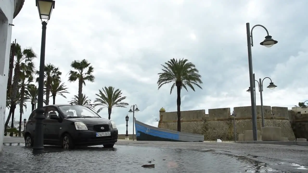 Car parking in a gigantic puddle after heavy rain in Cadiz Spain