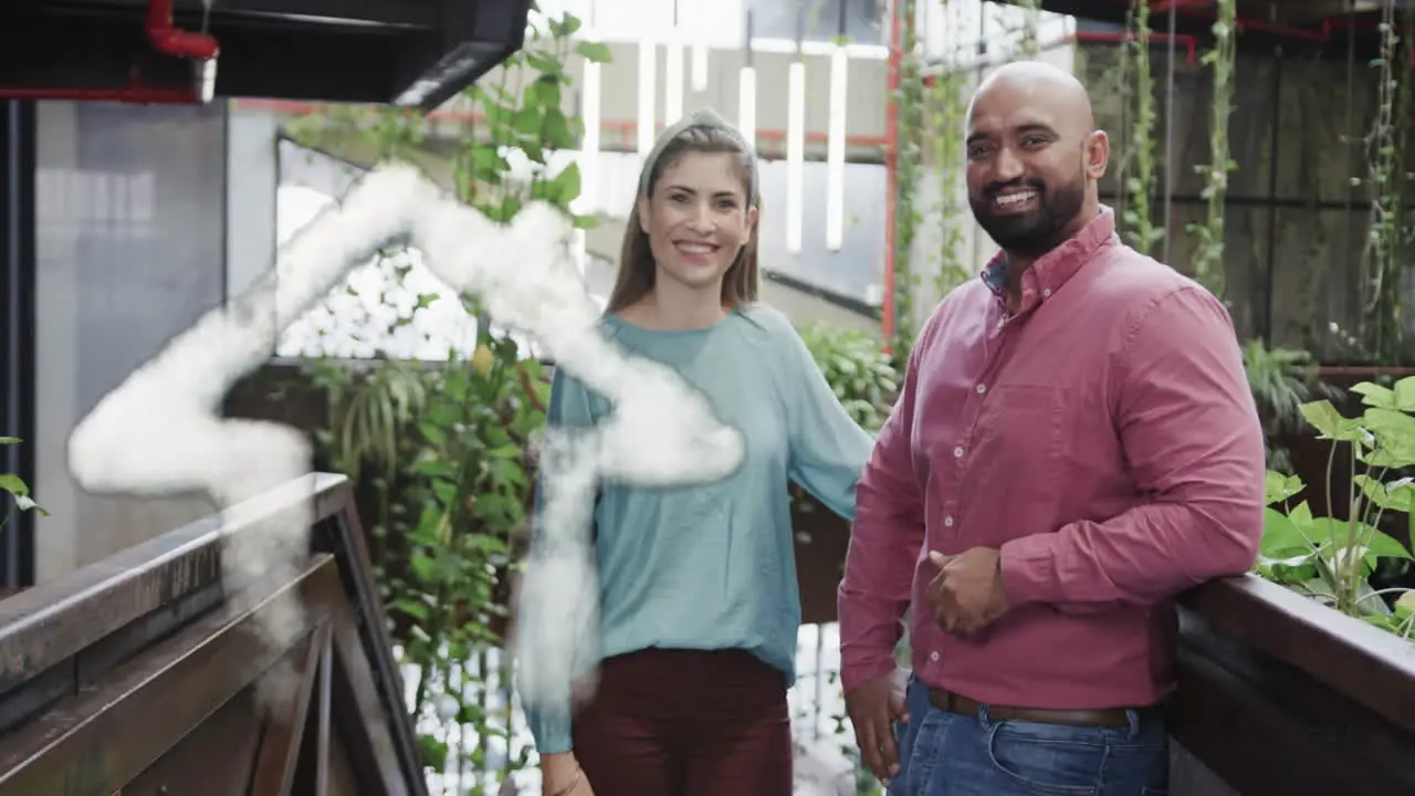 Animation of cloud house icon over happy diverse couple on balcony