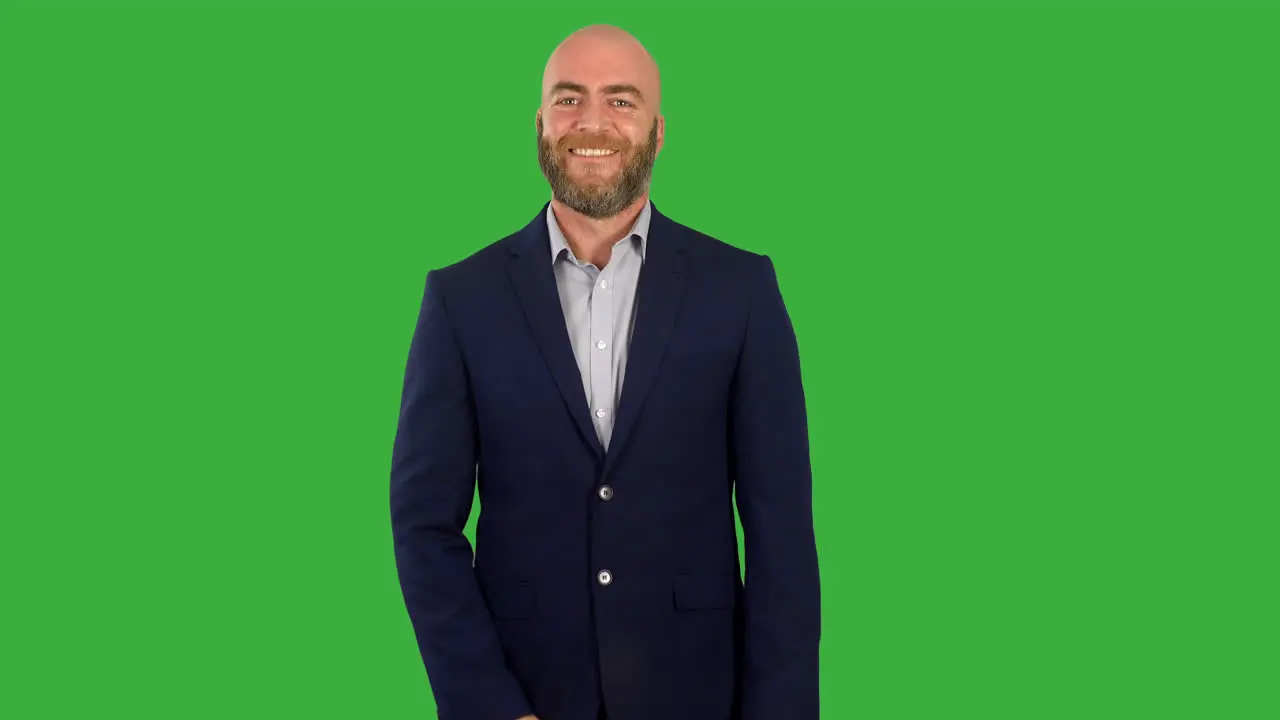 A businessman with a beard nodding yes in agreement on green screen