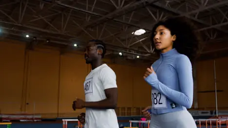 Man and woman running indoors