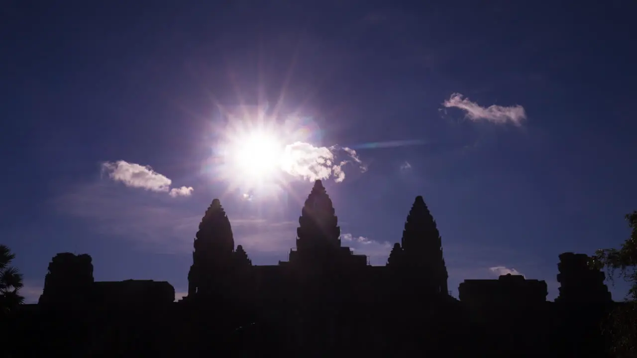 Angkor Wat silhouette with star sun and fluffy clouds zoom out