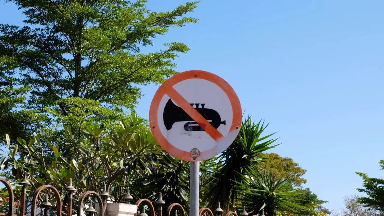 Close up of noise control sign post for no music outside a church in Dili Timor-Leste