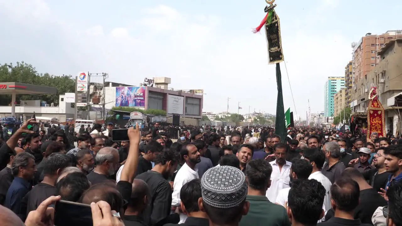 Large Group Of Men In Crowd Chanting In Unison At Parade Of Muharram In Karachi