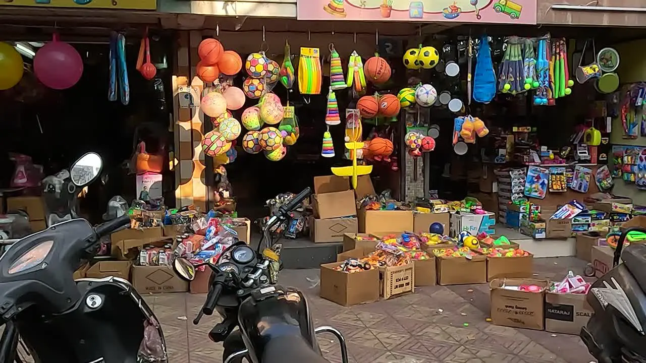 Wide shot of traditional toys of where people are shopping on festive days